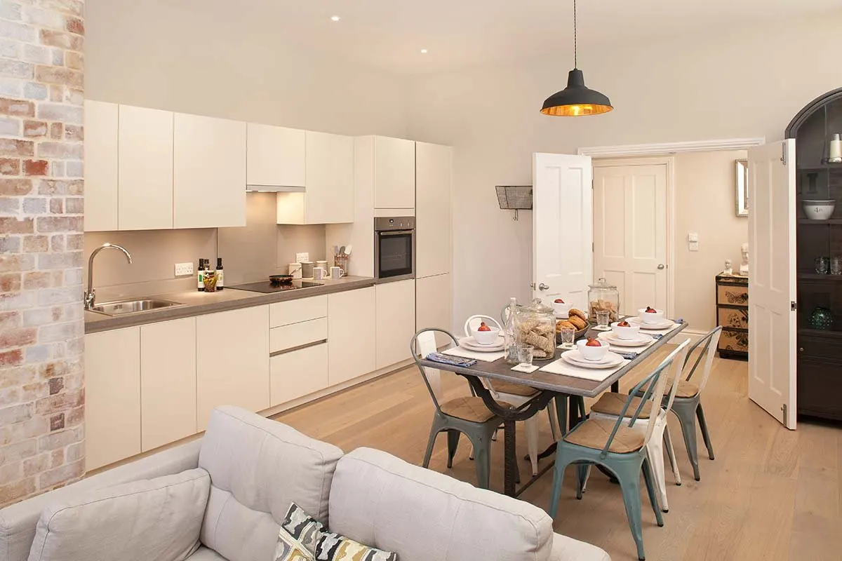 Show apartment lounge, kitchen and dining area with arched windows