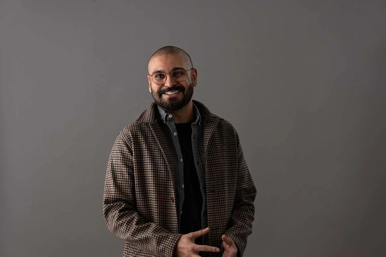 Business headshot against a grey studio backdrop