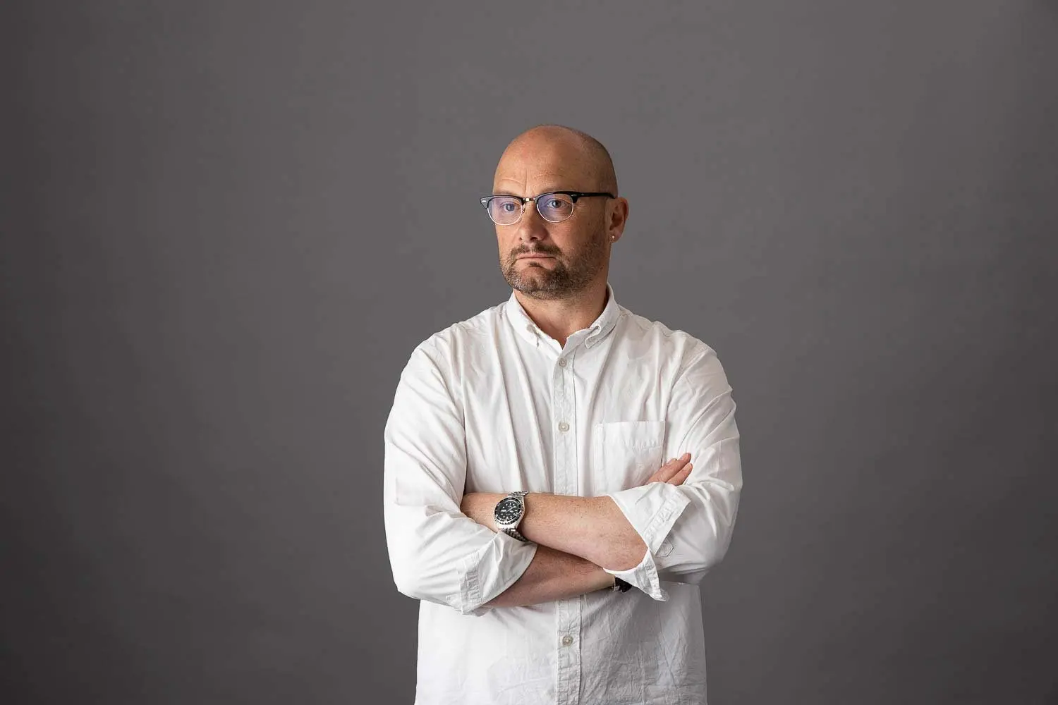 Business headshot against a grey studio backdrop