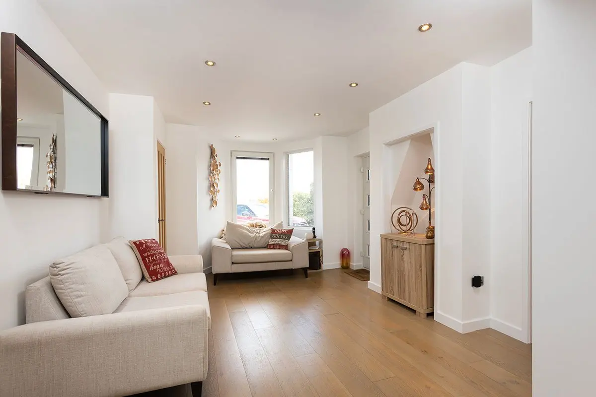 Bright lounge with cream sofas and wooden floors