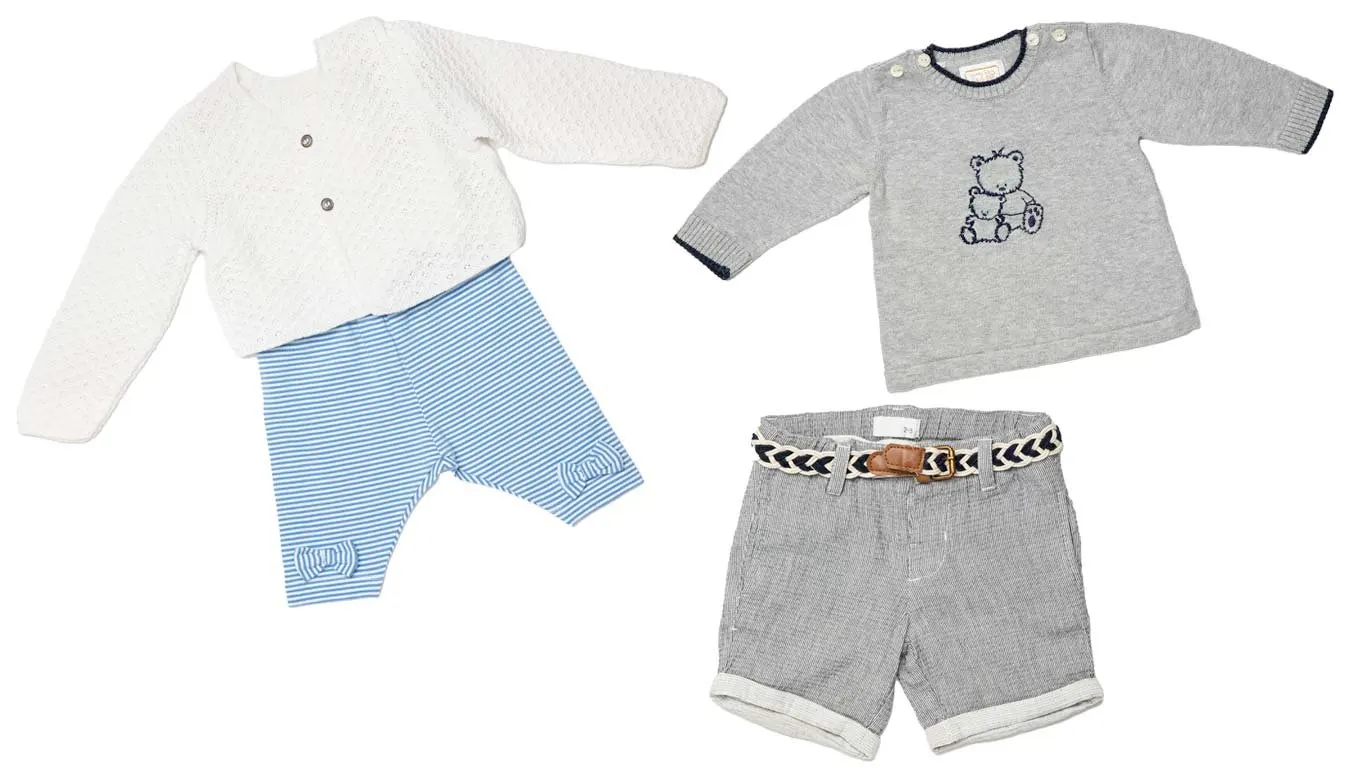 Baby clothes laid flat on white