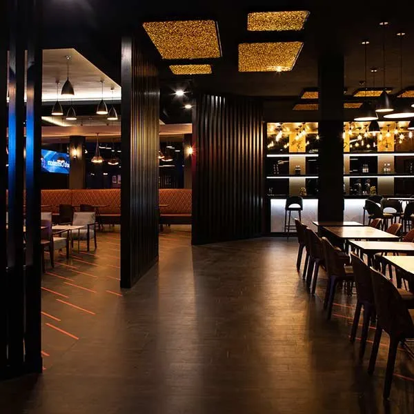 Bar seating with dark wood panelling
