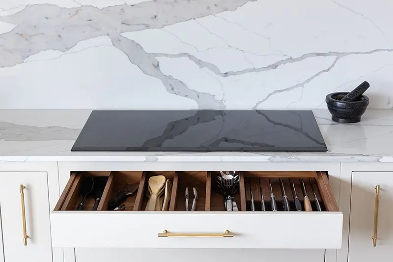 Induction hob above an open cutlery drawer