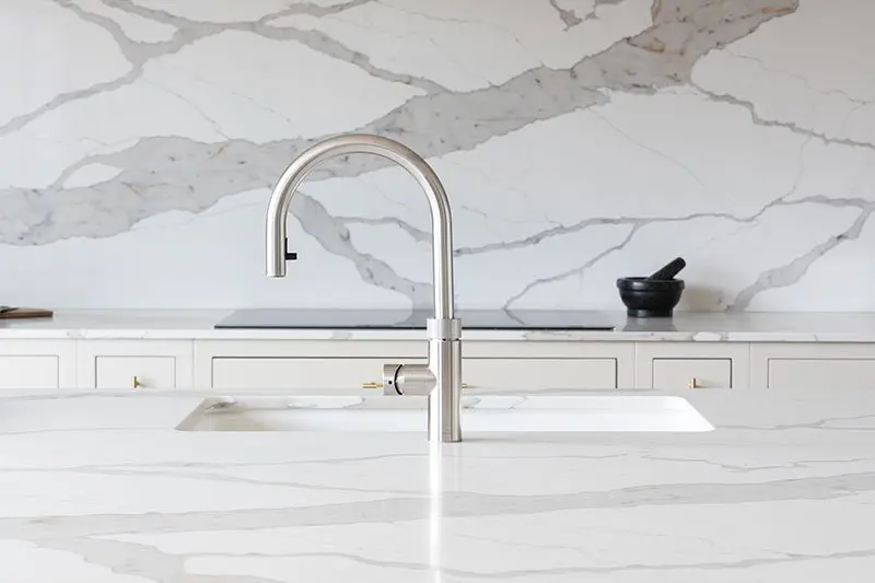 Brushed steel tap on the marble worktop