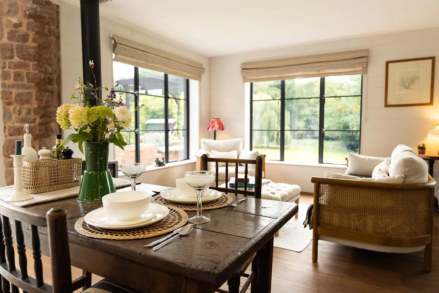 Dining table set for a meal, with wild flowers