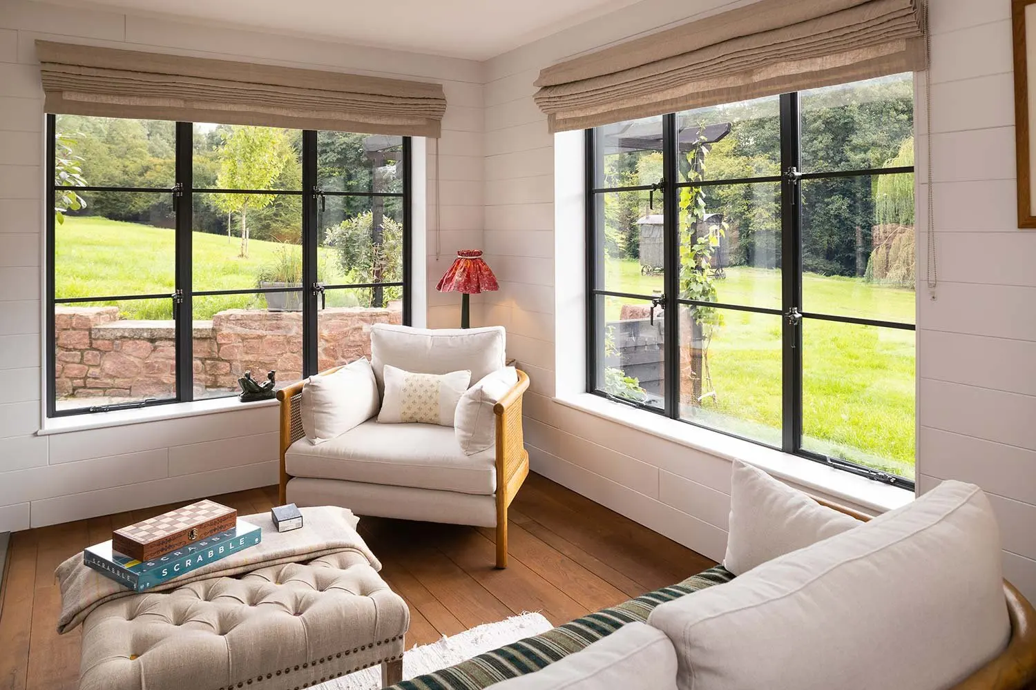 Armchair by tall windows overlooking the garden