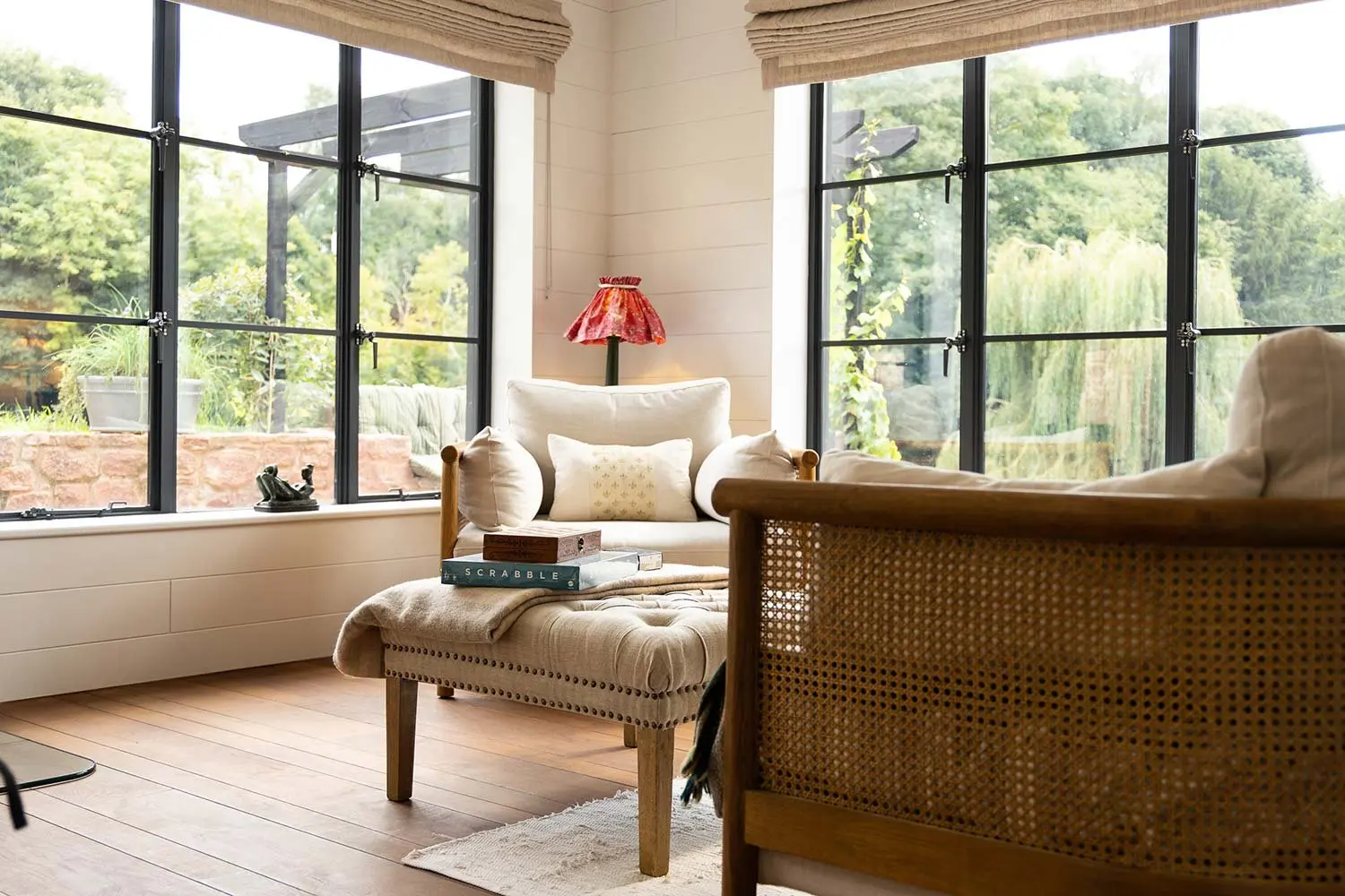 Cane armchair and sofa by the windows