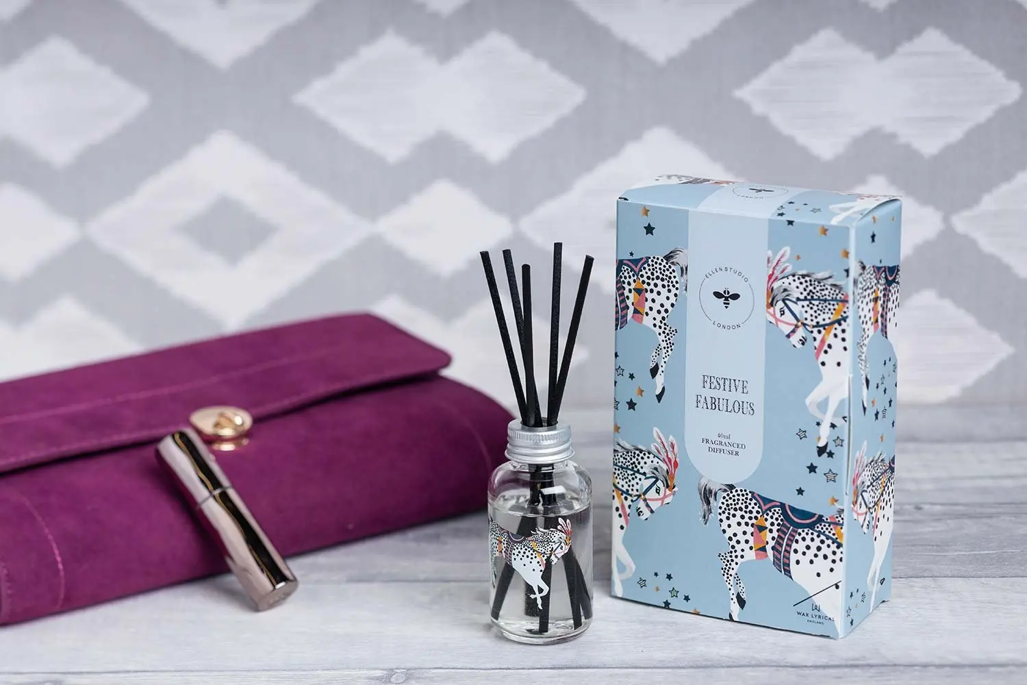 Gift set with a reed diffuser on a purple cushion