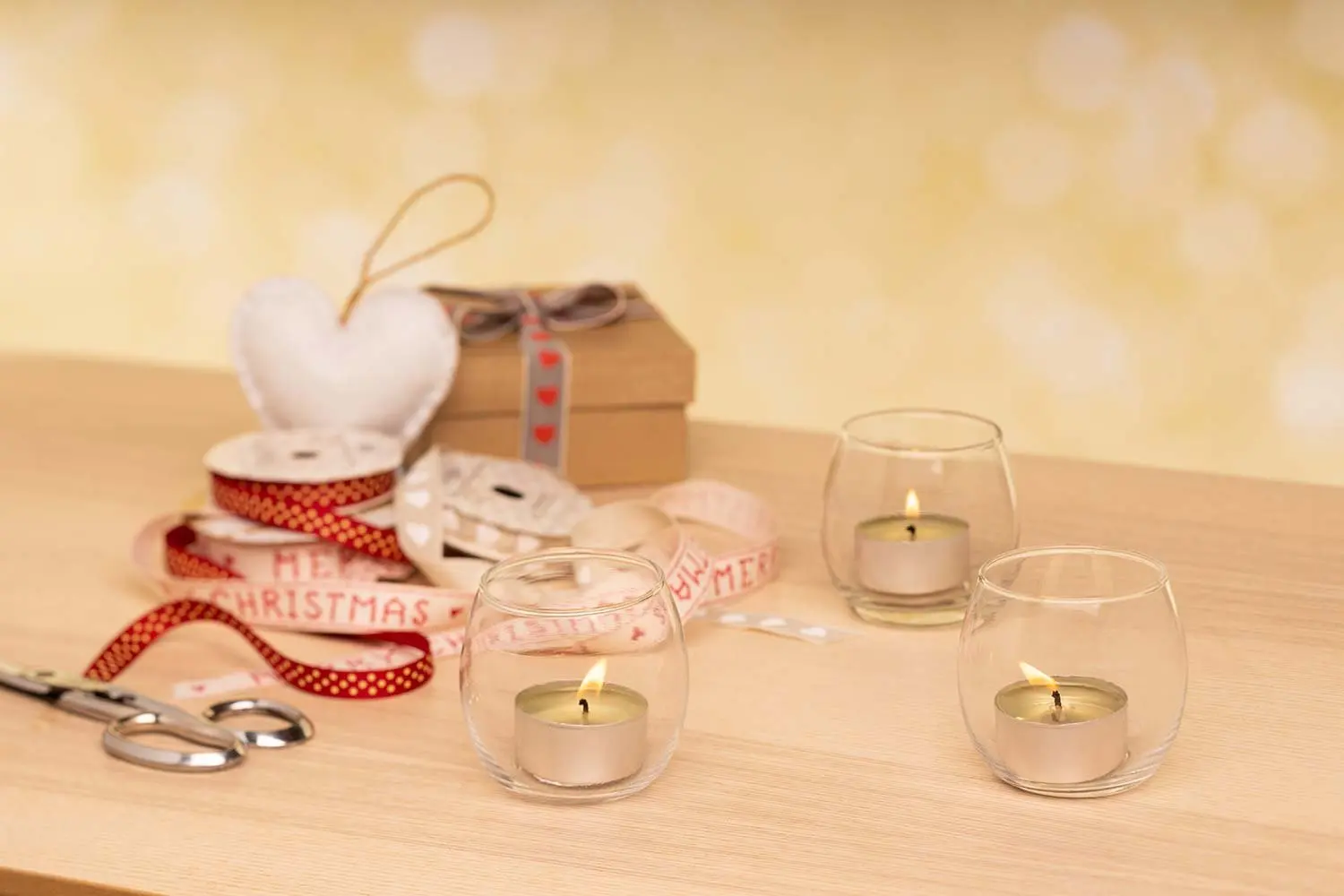 Tealight holders lit on a wooden table
