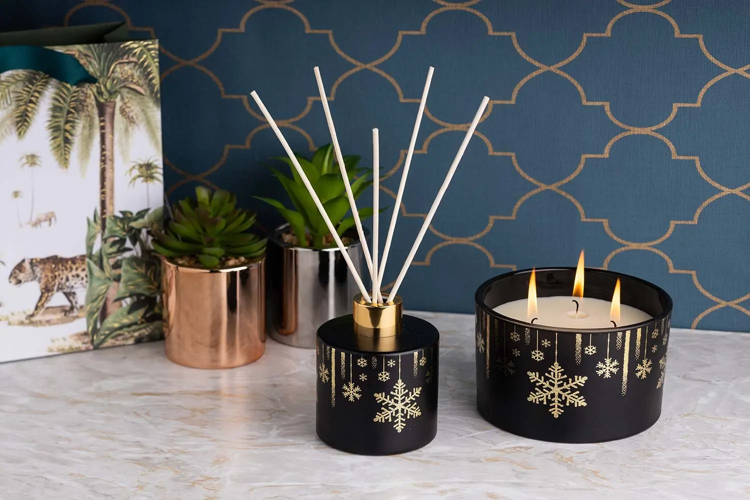 Black and gold candles with a reed diffuser