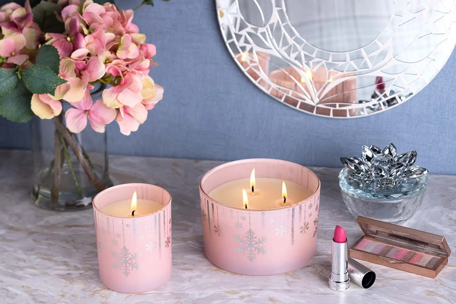 Pink candles with flowers and make-up