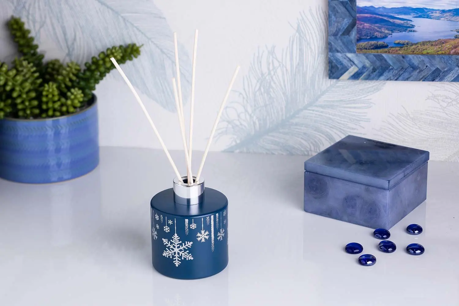 Navy reed diffuser with a festive backdrop