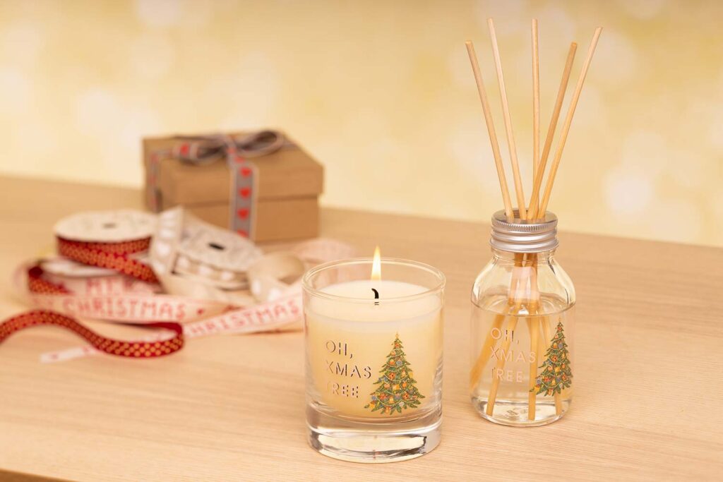 styled Christmas product photography xmas candle lit with reed diffuser